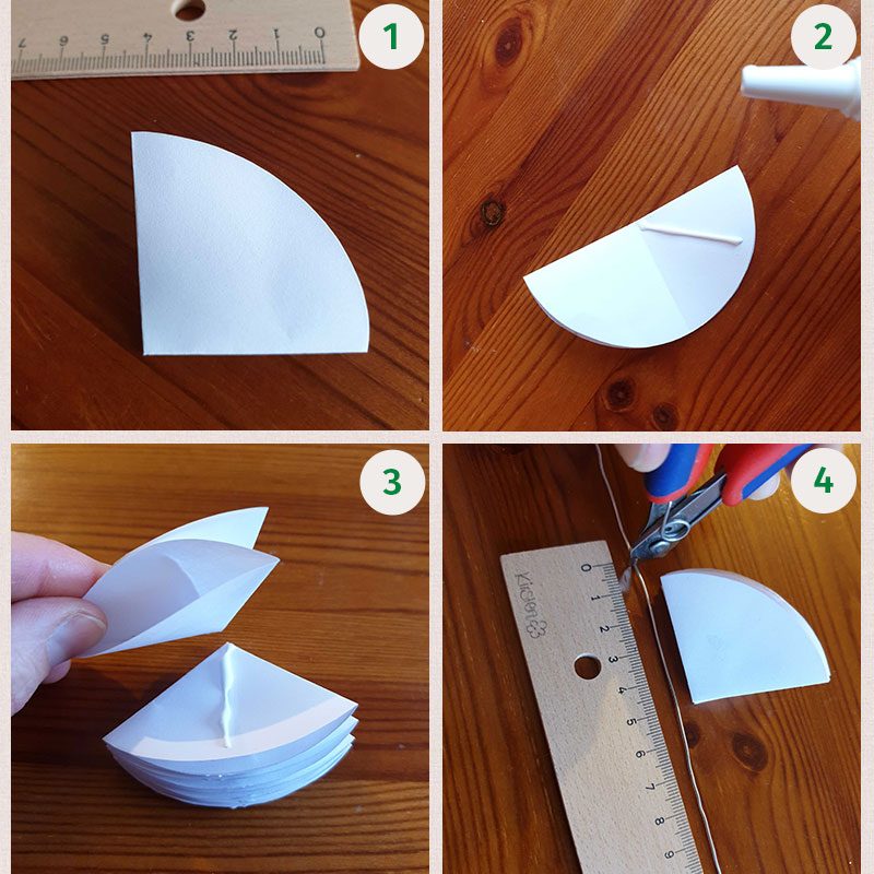 Die vier Bilder zeigen, wie die Regenschirme aus Papier gebastelt werden.