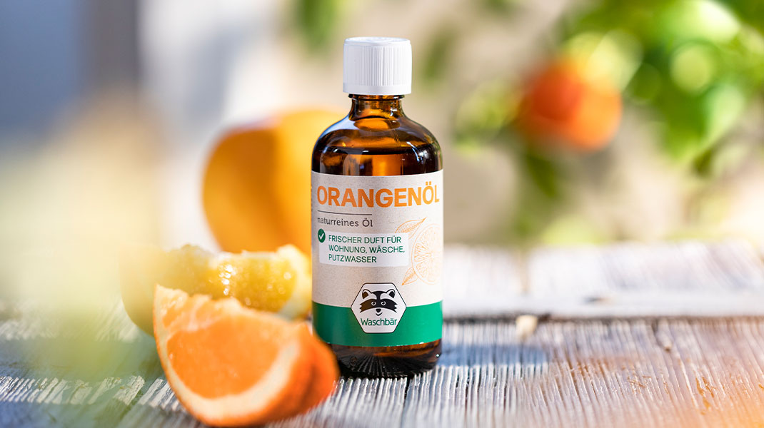 Ätherisches Orangenöl in sommerlicher Umgebung